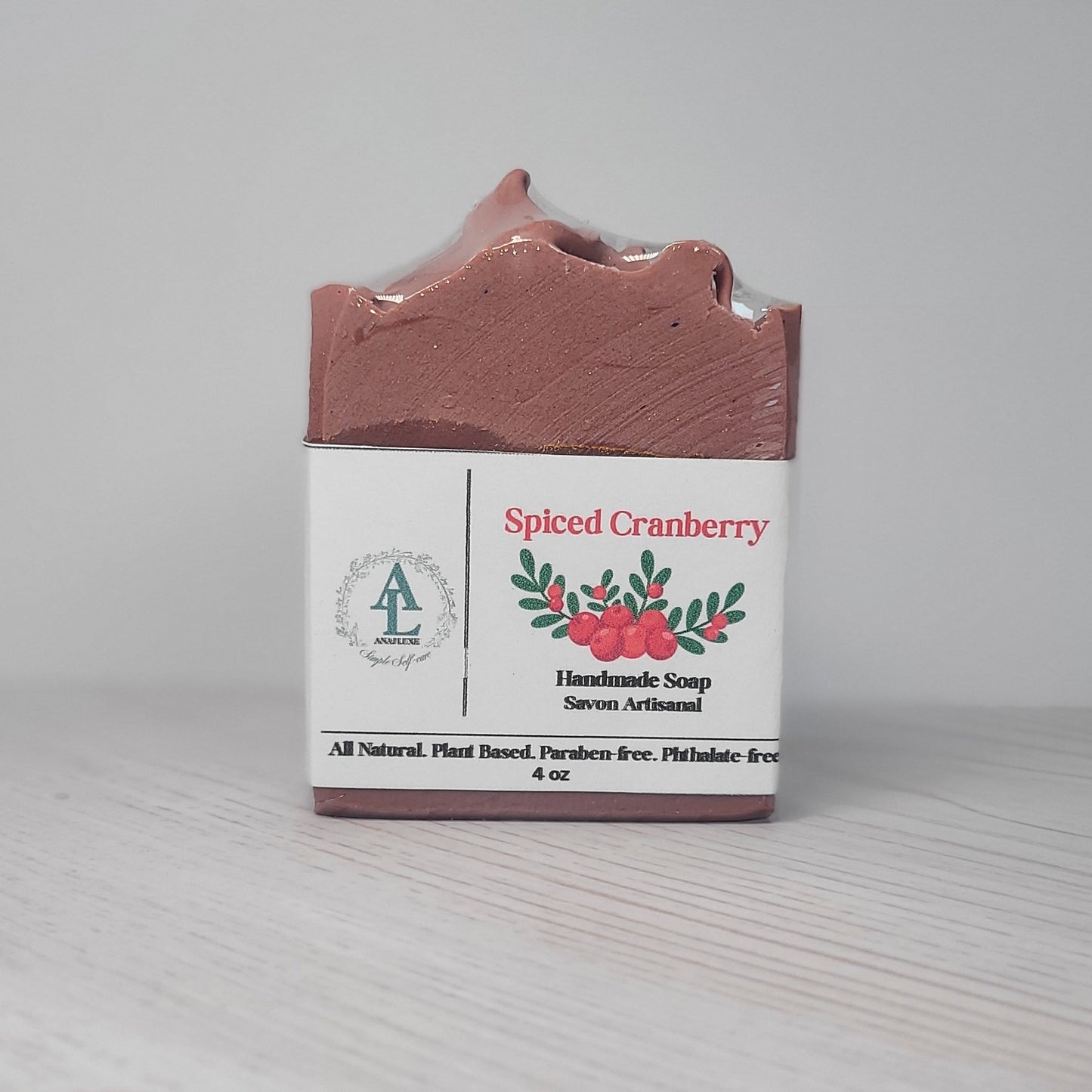 Spiced Cranberry handmade soap bar with packaging on a light gray background