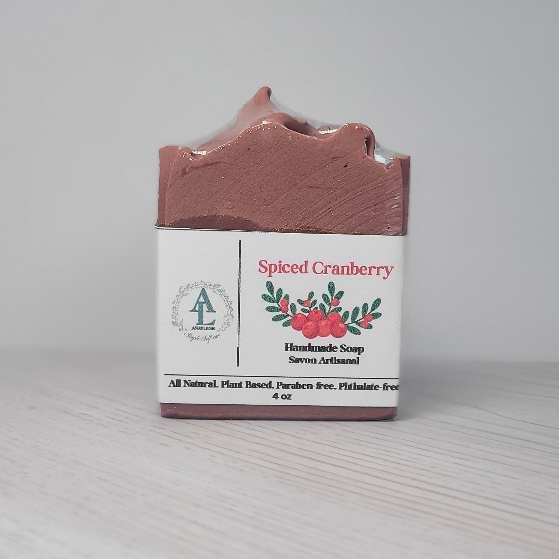 Spiced Cranberry handmade soap bar with packaging on a light gray background